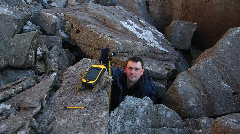 Aled Williams measuring the offset between the Trimble’s internal antenna and the ground at the base of the boulder field  © Myrddyn Phillips