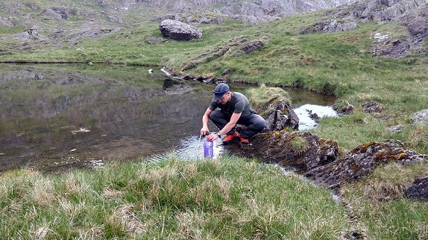 Refilling water bottles on a hot day in the Welsh mountains  © Toby Archer