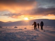 Mountaineers begin to descend at sunset above Corrie an t-Sneachda in Cairngorms National Park, Scotland.