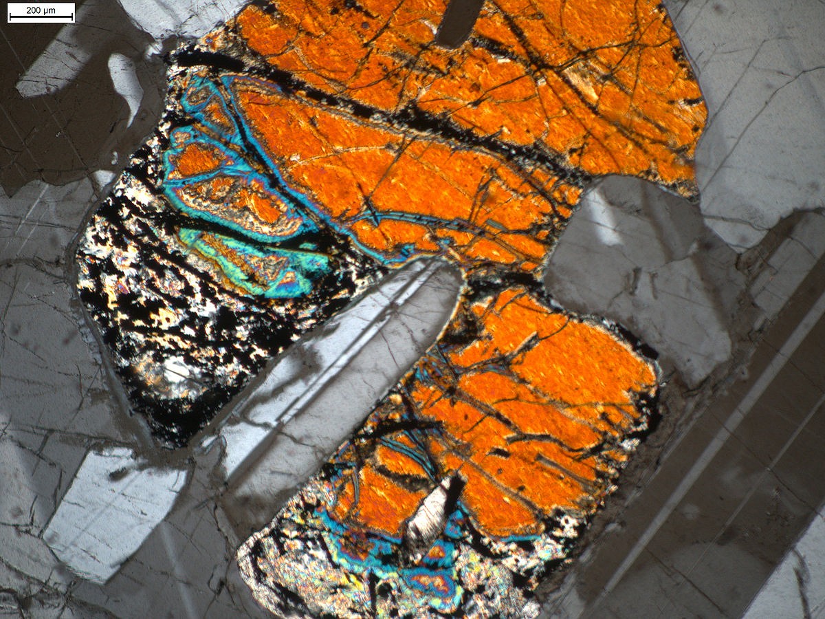Gabbro under a microscope. The coloured shapes are the interlocking crystals that give gabbro its characteristic grip.  © UKC Articles