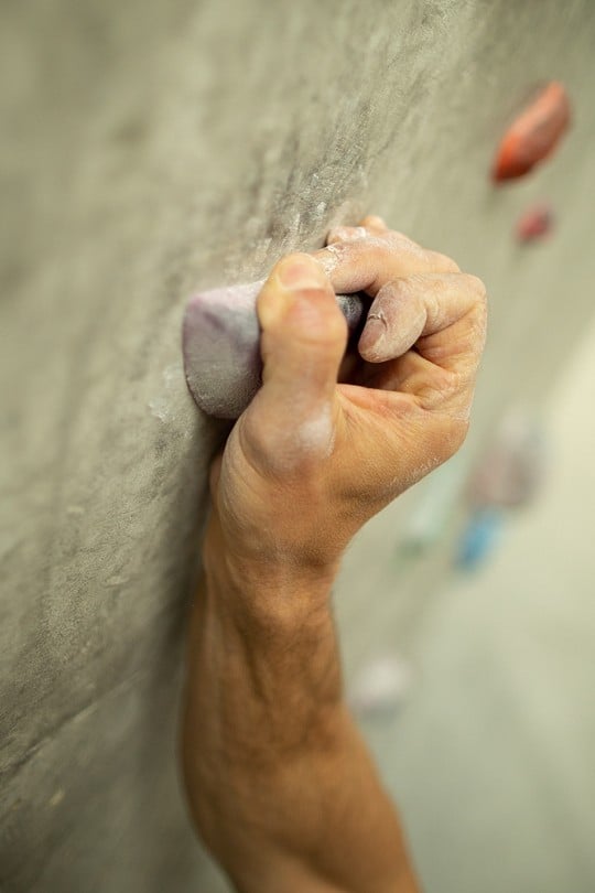 A variation on guppying which can be used on shallow holds is to wrap the pinky and ring fingers around the side and then 'crimp' with the thumb.  © Nick Brown - UKC