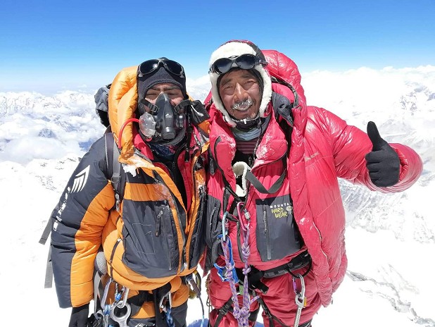 Chatur Tamang, right, on the summit in 2019.  © Chatur Tamang