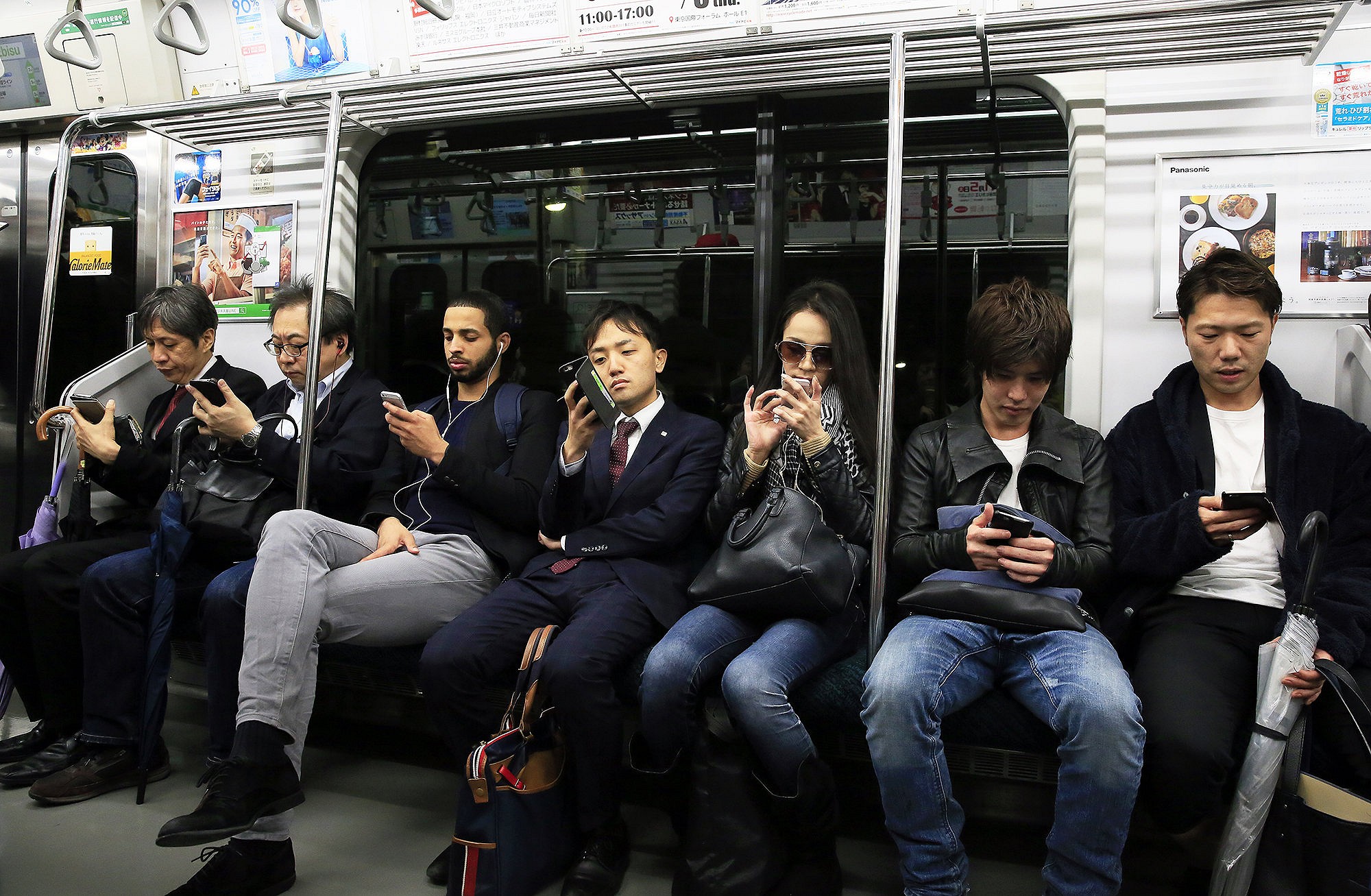 On a commuter train in Tokyo, Japan, the consequences of digital addiction are strikingly obvious.  © David Pickford