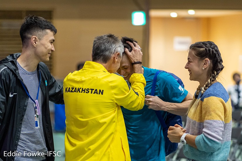 Rishat Khaibullin (KAZ) is told that he's qualified for an Olympic quota place.  © Eddie Fowke/IFSC