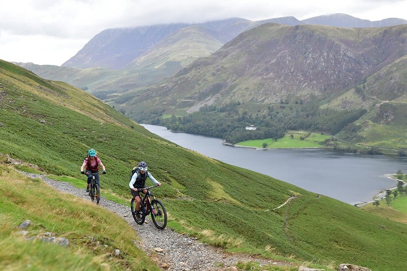 Katy Forrester and Meg Whyte riding Scarth Gap Pass above Buttermere.  © Henry Iddon