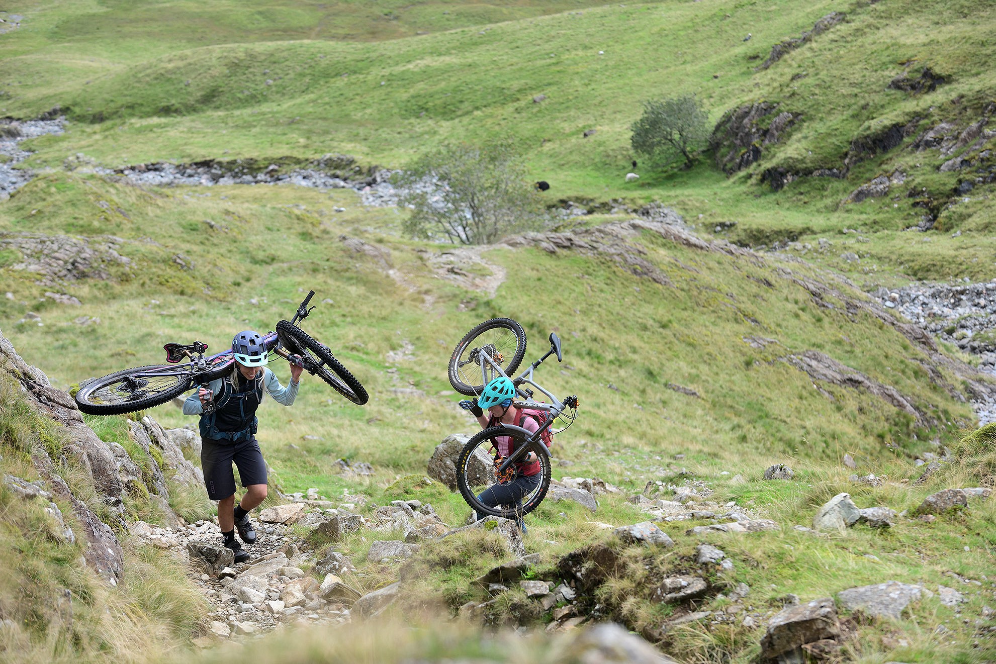 Meg Whyte and Katy Forrester, getting in some hike-a-bike on Black Sail Pass, Ennerdale.  © Henry Iddon