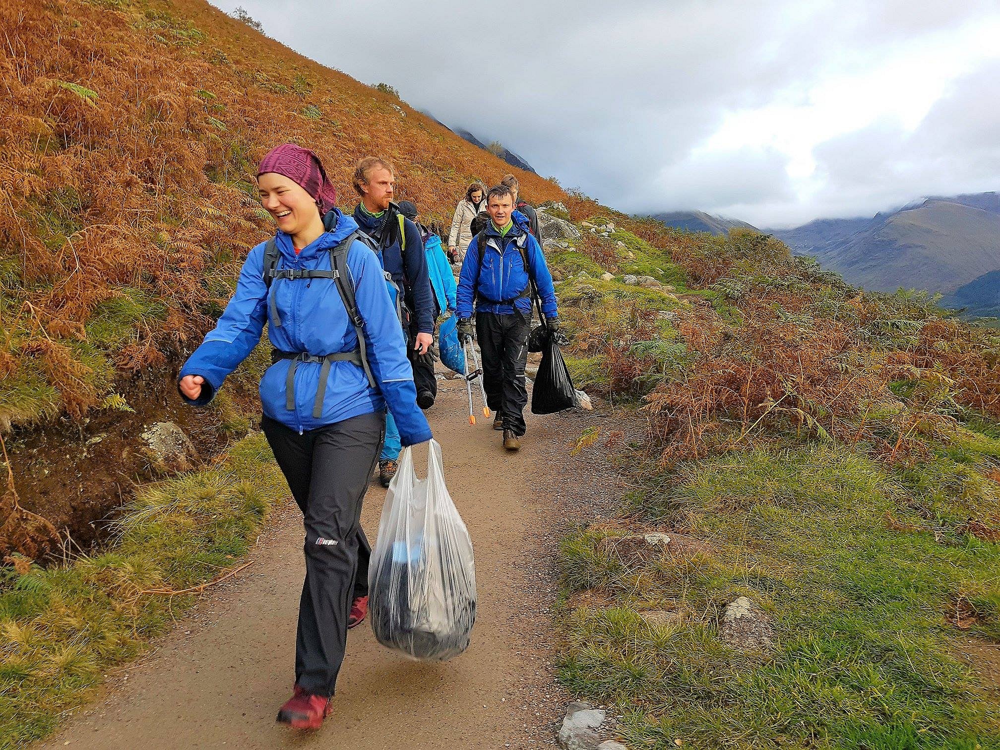 Volunteers on a previous event carry their haul off Ben Nevis  © Real3Peaks Challenge