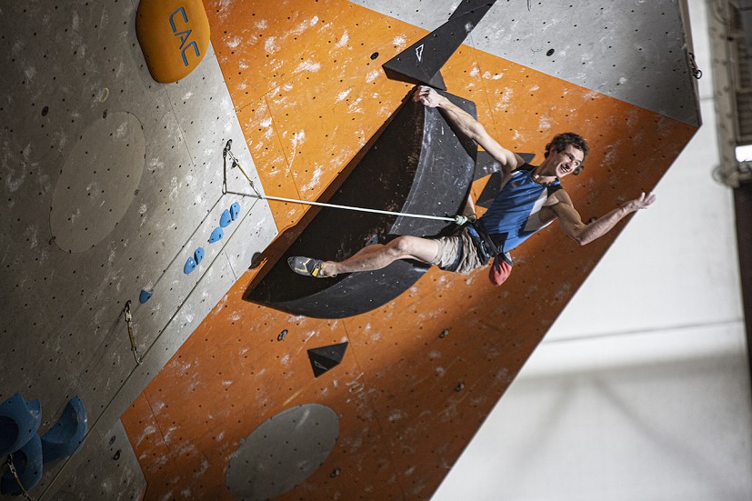 Adam Ondra asks for more energy from the crowd during his winning final climb.  © Final Crux Films
