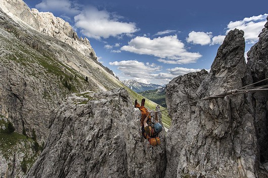 James Rushforth making the characteristic tyrolean traverse of Via vuoto d'aria (5a) at Porte Neigre.  © Lynne Hempton