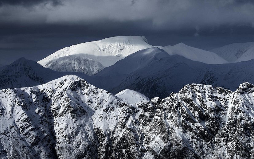Ben Nevis and the Aonach Eagach lit up on a moody winters day  © Hamish Frost