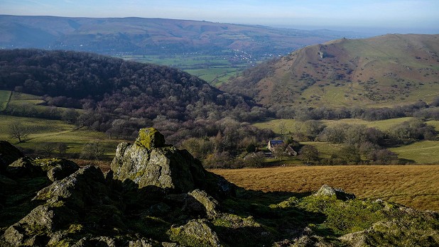 Looking west across Cwms Valley to the Long Mynd, with the wooded Helmeth Hill to the left and Caer Caradoc to the right  © John Gillham
