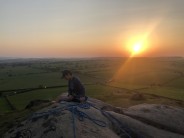 Alex Law at the top of Almscliffe belaying on The Traditional Climb