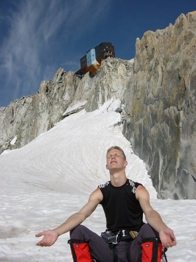Arron worshiping the sun under the cosmiques hut  © Phil Payne