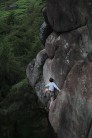 Harry Woods committing to the crux move on Valkyrie, VS 4c.