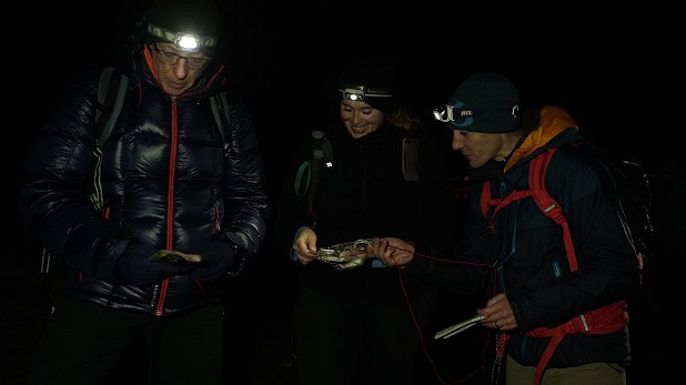 Navigating off the hill in darkness. Headtorches are an essential piece of kit.   © Paul Diffley