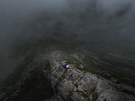Kathryn making the final exposed moves on Cneifion Arete in Ogwen, Snowdonia.  © Matt Cooper