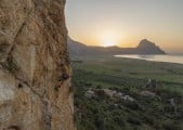 Daimon Beail catching the last rays of sunshine on Benna (6b) on the Castelluzzo Outdoor Wall.<br>© Alan James