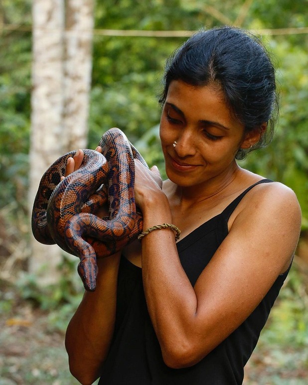 Gowri with a Rainbow Boa snake.  © Gowri Varanashi