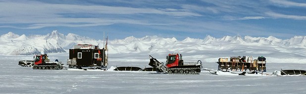 Tractor Traverse on the Rutford Ice Stream with the Ellsworth mountains behind.  © Tim Gee