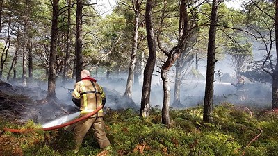 Firefighting after a camp fire caused a wildfire on Beinn Eighe and Loch Maree Islands National Nature Reserve  © Doug Bartholomew/NatureScot