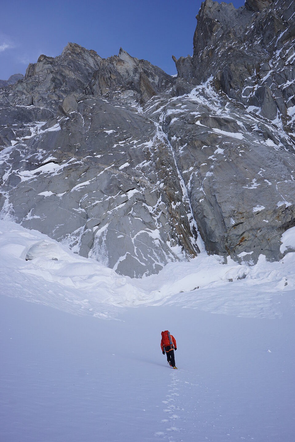 Matt approaching the base of the route on the first day. It takes the obvious thin couloir straight above.  © Tom Livingstone