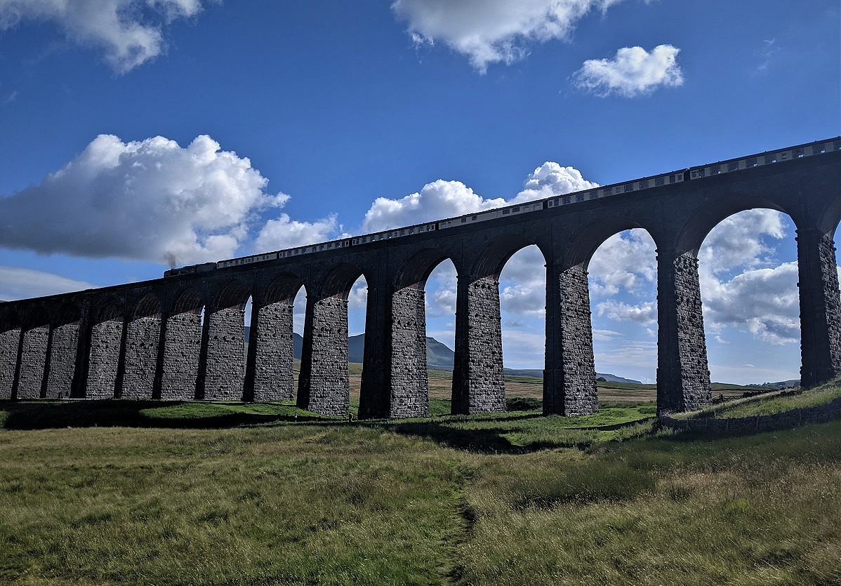 Steam train crossing the mighty Ribblehead Viaduct  © Chris Scaife