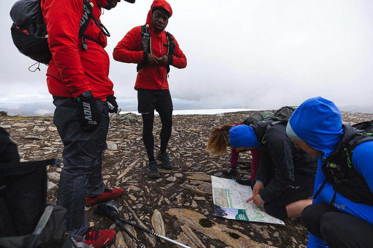 Consulting the map on the summit of Aonach Beag and considering options for descending to Glen Nevis at the end of day 3  © inov8 - Black Trail Runners - Johny Cook