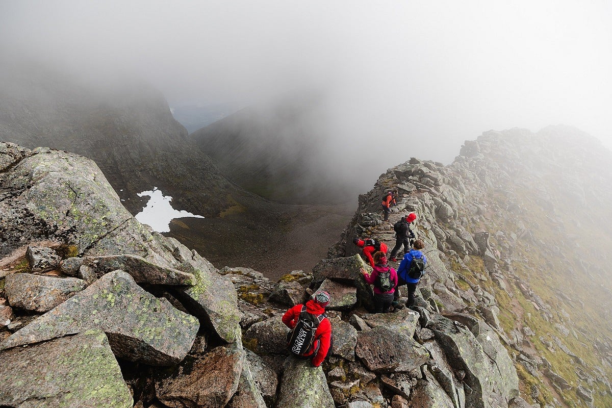 Taking on the scramble along the Carn Mór Dearg arête, having just descended out of cloud shrouding Ben Nevis  © inov8 - Black Trail Runners - Johny Cook