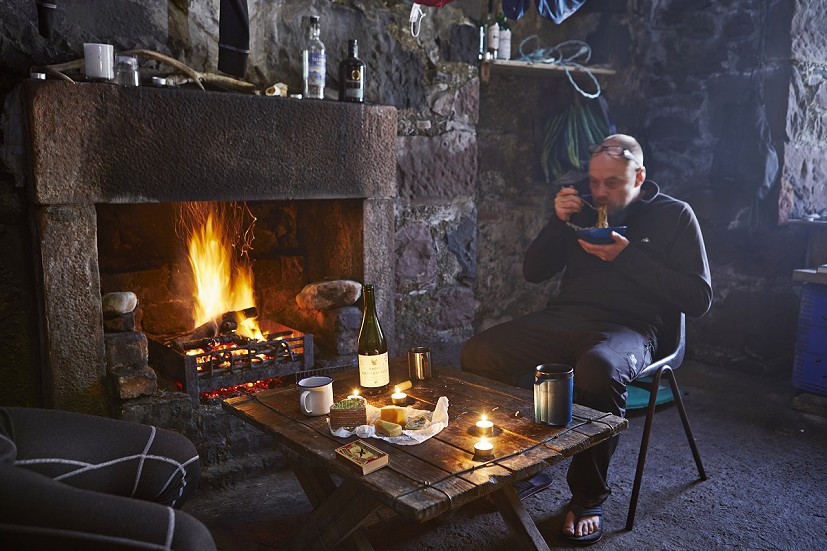 Wine, cheese, instant noodles - a few luxuries can make all the difference. Geoff Allan at Guirdil Bothy  © Jonathan Andrew