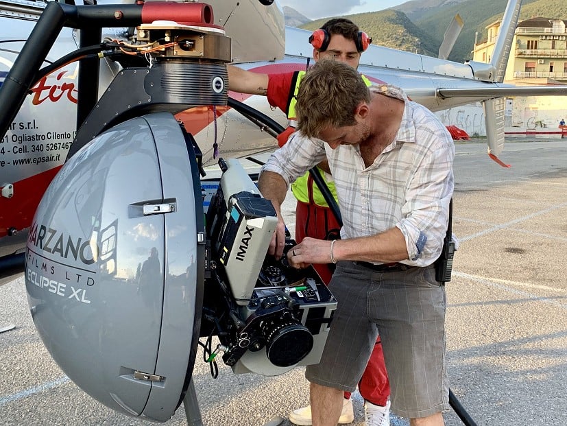 Charlie working on the camera equipment attached to a helicopter for aerial shots.  © Charlie Woodburn