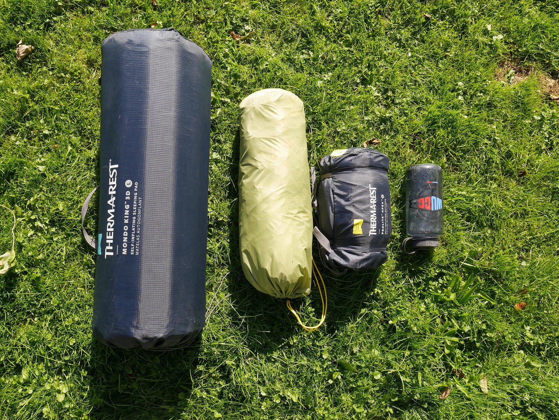 Left to Right: MondoKing, one man tent, standard self inflating mat, water bottle.  © UKC Gear