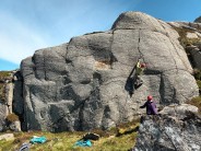 View of Sgarastaigh craglets with David K climbing micro-domo HVS 5b on the right-hand side, belayed by Rowan E. All four origi