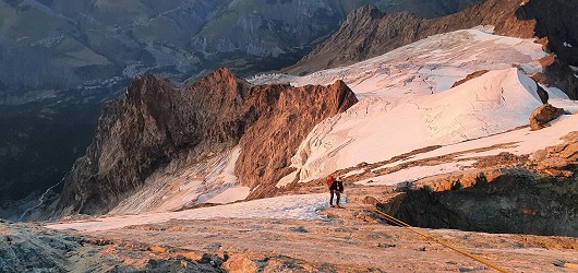 Lada abseiling off the fourth tooth between the Grand Pic du Meije and Doite du Dieu as the sun sets  © gtaylor997
