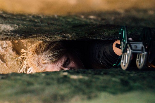 Jess struggling to get the cam high enough in the crack, before going for it.  © climberinspace