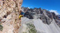 Paul Platt, in his new yellow pants, following the traverse pitch on the Cassin route on Cima Piccolisima