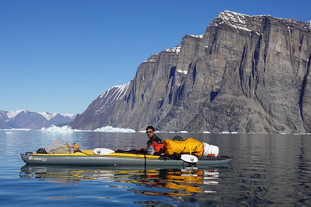 Jacob early on in the journey with some huge (and chossy!) cliffs near Uummannaq behind  © Bronwyn Hodgins @bronwynhodgins