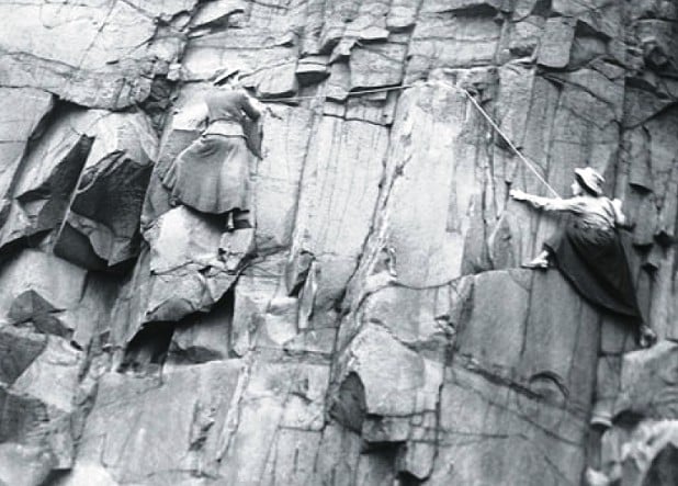 Lucy Smith and Pauline Rankin rock climbing in skirts on Salisbury Crags, Edinburgh. 1908.  © Harold Raeburn - Digital reproduction or scan of original