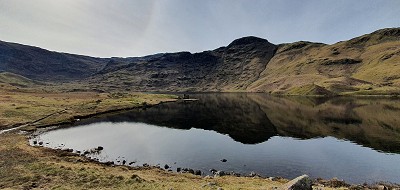 The darkling waters of Easedale Tarn (not actually en route but encircled by it)  © Norman Hadley