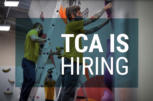 TCA is hiring written over a picture of 2 route setters working in a climbing wall   © The Climbing Academy