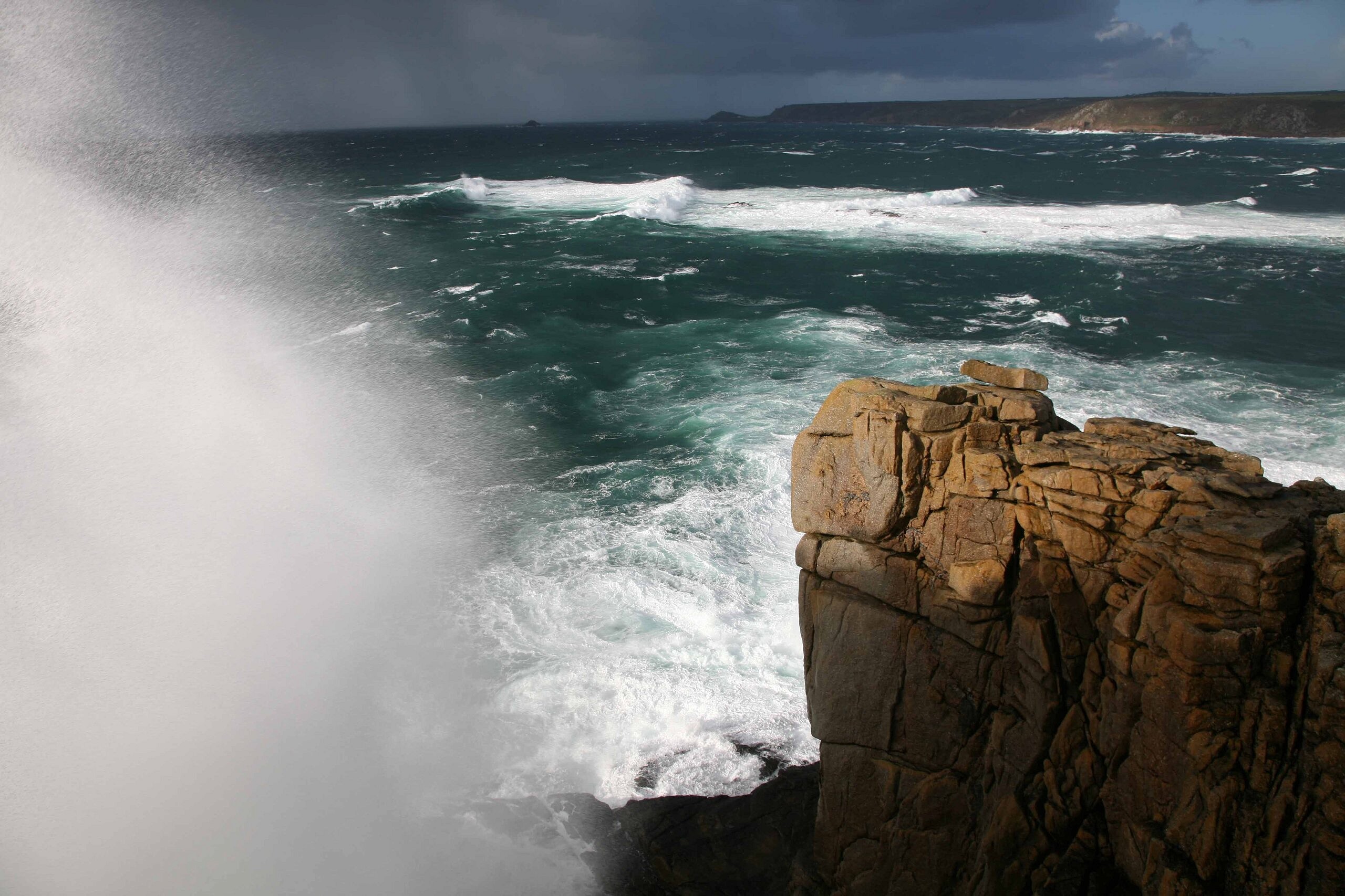 A huge wave breaks over the top of the Sennen cliffs in West Penwith, Cornwall, in a Force 9 gale.   © Dave Pickford