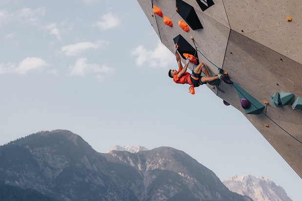 Olympic champion Alberto Ginés López (ESP) climbing against the backdrop of Innsbruck's mountains.  © Jan Virt/IFSC