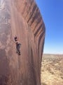 Rowan standing on the shadows of his shoes - onsight of Living Like Shadows on the very photogenic Amalu Wall in Tafraoute. Stu<br>© ArlieH
