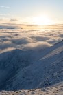 Watching the endless stretch of cloud, as the sun sets, just beyond the snowy summit of Blencathra.