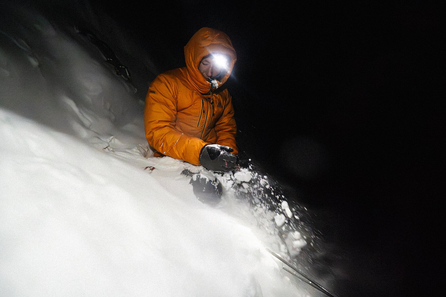 Trying to excavate our collapsed tent and equipment during the night, our efforts being undone by continuous flows of spindrift  © Hamish Frost