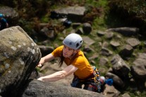 Reaching for the next hold on Birchen Edge.