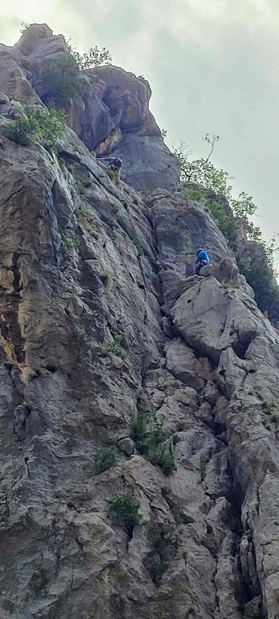 Heading out on pitch 2 from the ledge, trad belay stance. The bolted belay is to the right of the climber.  © Apapap