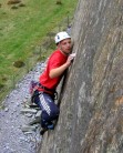 Aly - tongue out, climbing hard on slate