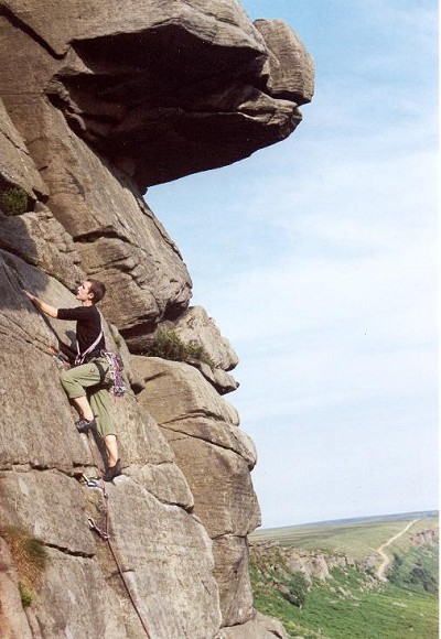 Pat not jamming on Inaccessible Crack (VS 4c), Stanage High Neb; Quietus (E2 5c) looms behind  © Paul Wolfson