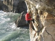 Alexander Thorp at the belay of Pigs On The Wing (HVS), Triple Overhang Buttress, Pembroke