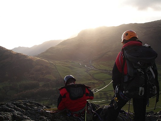 Ruth Snowden and Dave Smith on the second belay of Middlefell Buttress looking through into Little Langdale.  © Will Hunt